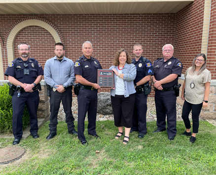 Seven people pose for award