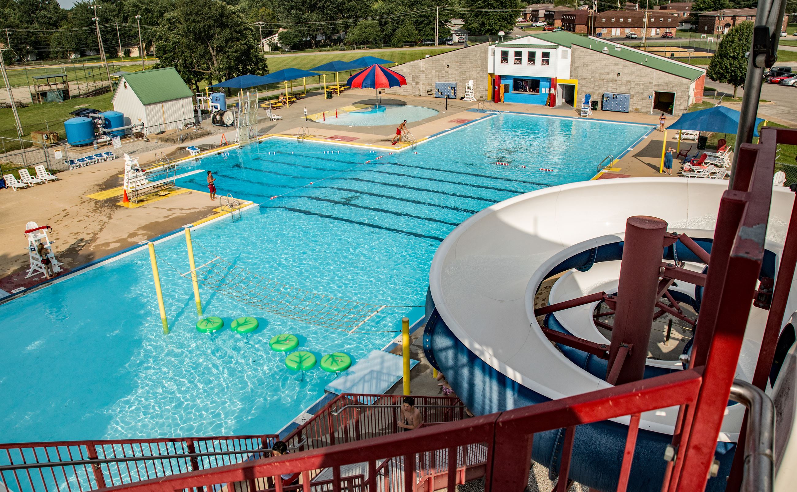 Boswell Aquatic Center in Lebanon, Missouri, with swimming pool, slide, and shaded seating area.