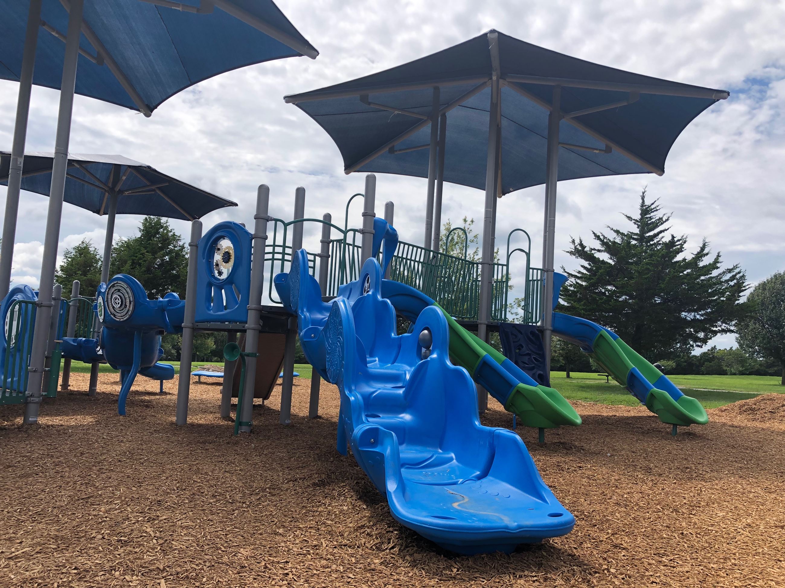 Harke Park in Lebanon, Missouri, showing playground, picnic shelter, and open green space with walki